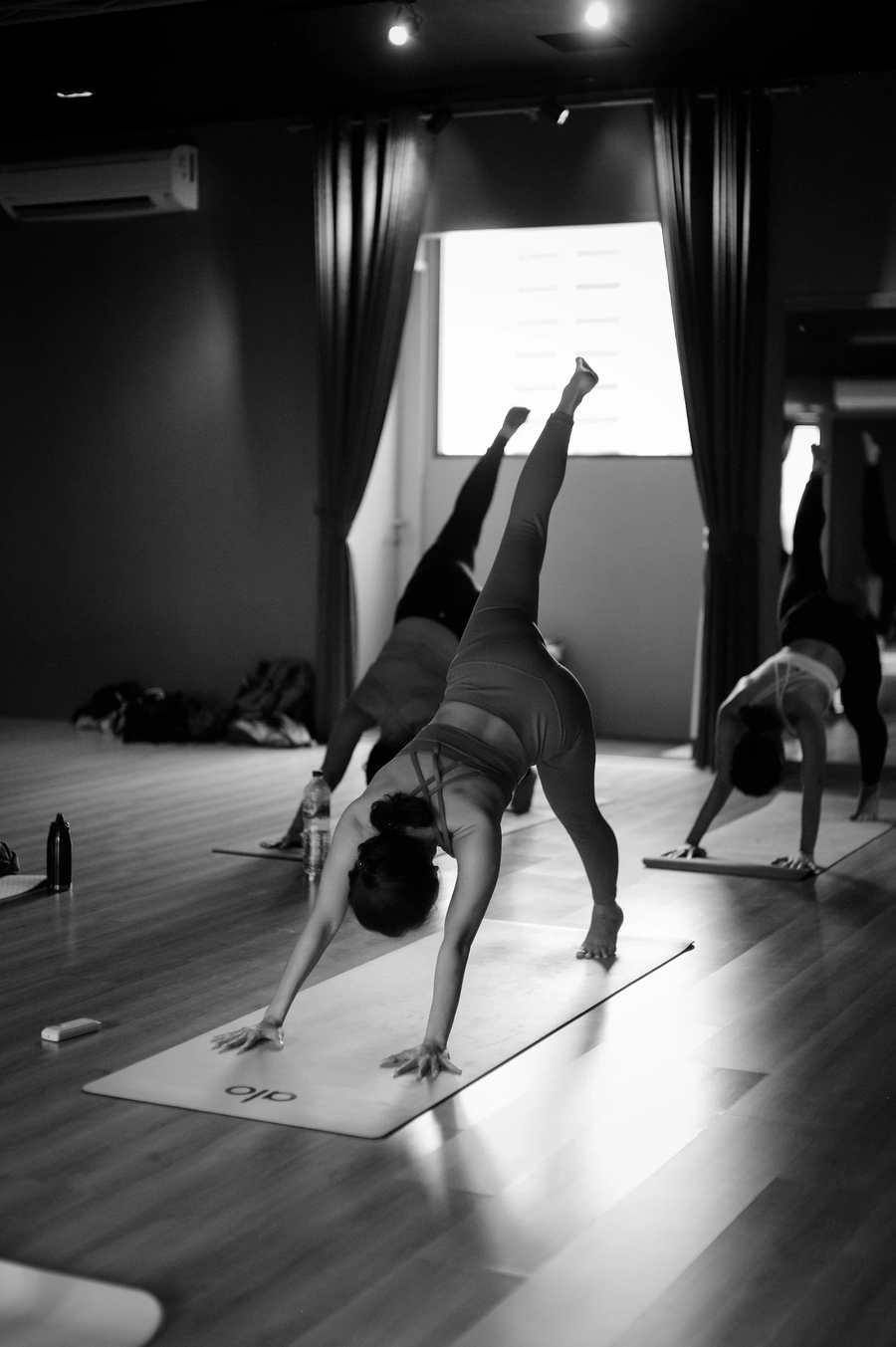 A group taking part in an indoor yoga class